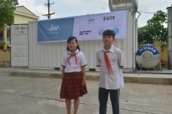 Two Vietnamese students standing side by side looking at the camera