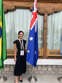 Rooan Al Kalmashi standing beside australian flag