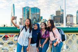 Students pose for a selfie on the Pyrmont Bridge