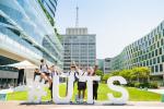 U@Uni Academy students standing in front of giant #UTS letters on the alumni green.