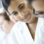 Young woman in lab coat.