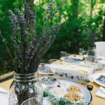 A jar of lavender in the foreground of a table laid out for Passover celebrations